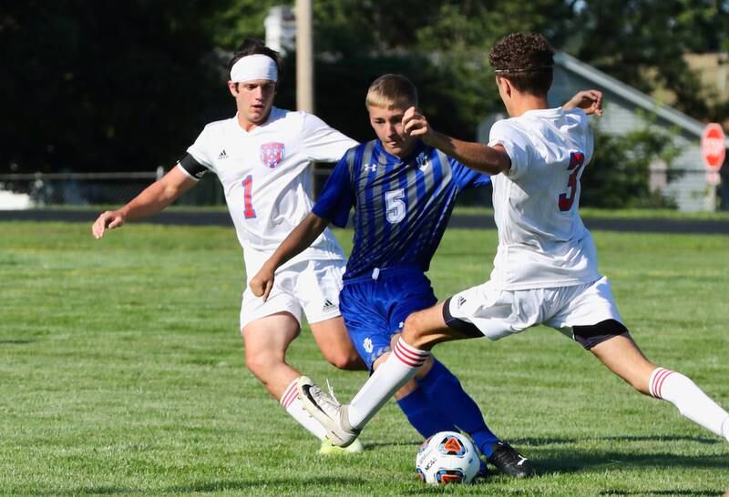 Princeton sophomore Zeke Klingenberg navigates between two Streator players in Monday's match at Bryant Field.