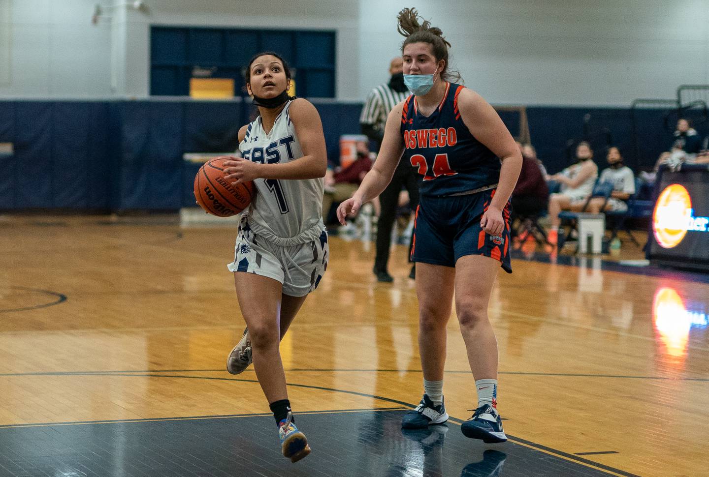Oswego East's Cami Phillips (1) drives to the basket against Oswego’s Kaila Schlinger (24) during a basketball game at Oswego East on Tuesday, Feb 8, 2022.