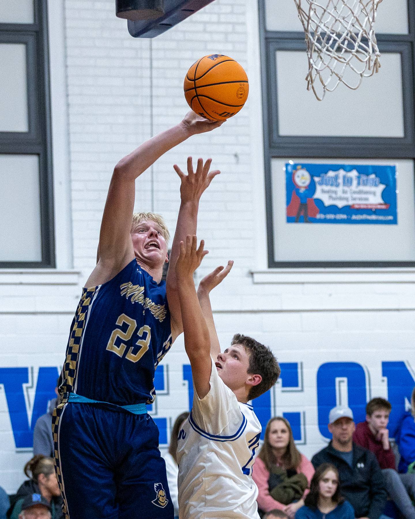 Marquette's Luke McCullough (23) shoots lay up as Cole Sateikis (21) of Newark contests shot on Thursday, January 22, 2026 at Newark High School in Newark.
