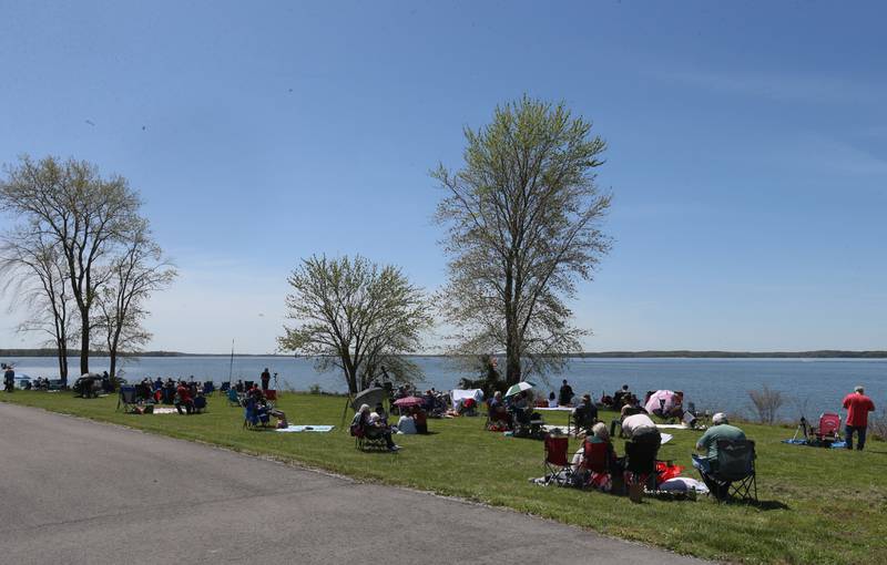 Hundreds of people view the total solar eclipse from Rend Lake near Whittington on Monday, April 8, 2024.
