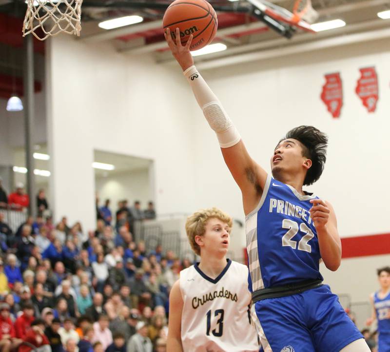 Princeton's Christian Rosario drives to the hoop past Marquette's Griffin Walker during the Colmone Classic tournament on Friday, Dec. 9, 2022 at Hall High School in Spring Valley.