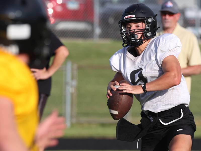Sycamore’s Griffin Larson looks to pass against Lena-Winslow Thursday, July 24, 2025, during a joint practice with Byron, Lena-Winslow and Sycamore at Sycamore High School.