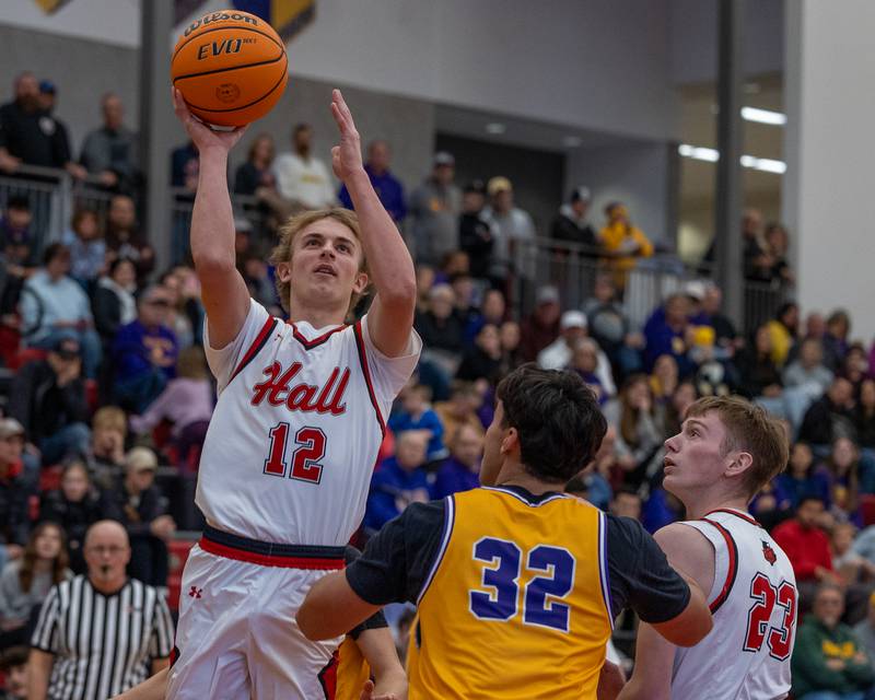 Hunter Edgcomb (12) of Hall lays ball up over Cam Wasmer (32) of Mendota in championship game of the Colmone Classic on Saturday, December 20, 2025 at Hall High School in Spring Valley.