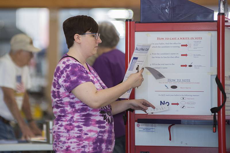 Shelby Melton starts the voting process Tuesday, June 28, 2022 at the mall in Sterling.