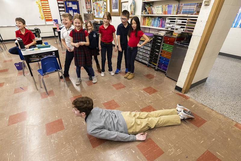 Newman High School freshman Roman Reynolds does his best work impersonation Wednesday, Jan. 29, 2025, for a group of third graders at St. Mary’s in Dixon. NHS students visited the school to play games with the kids in celebration of Catholic Schools Week.