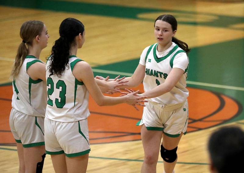 Alden-Hebron's Hayden Smith (right) greats her teammates, Nathalia Mendoza (center) and MacKenzie Maule (left) before the start of their nononference girls basketball game against Woodlands Academy on Thursday, Jan. 29, 2026, at Alden-Hebron High School in Hebron.