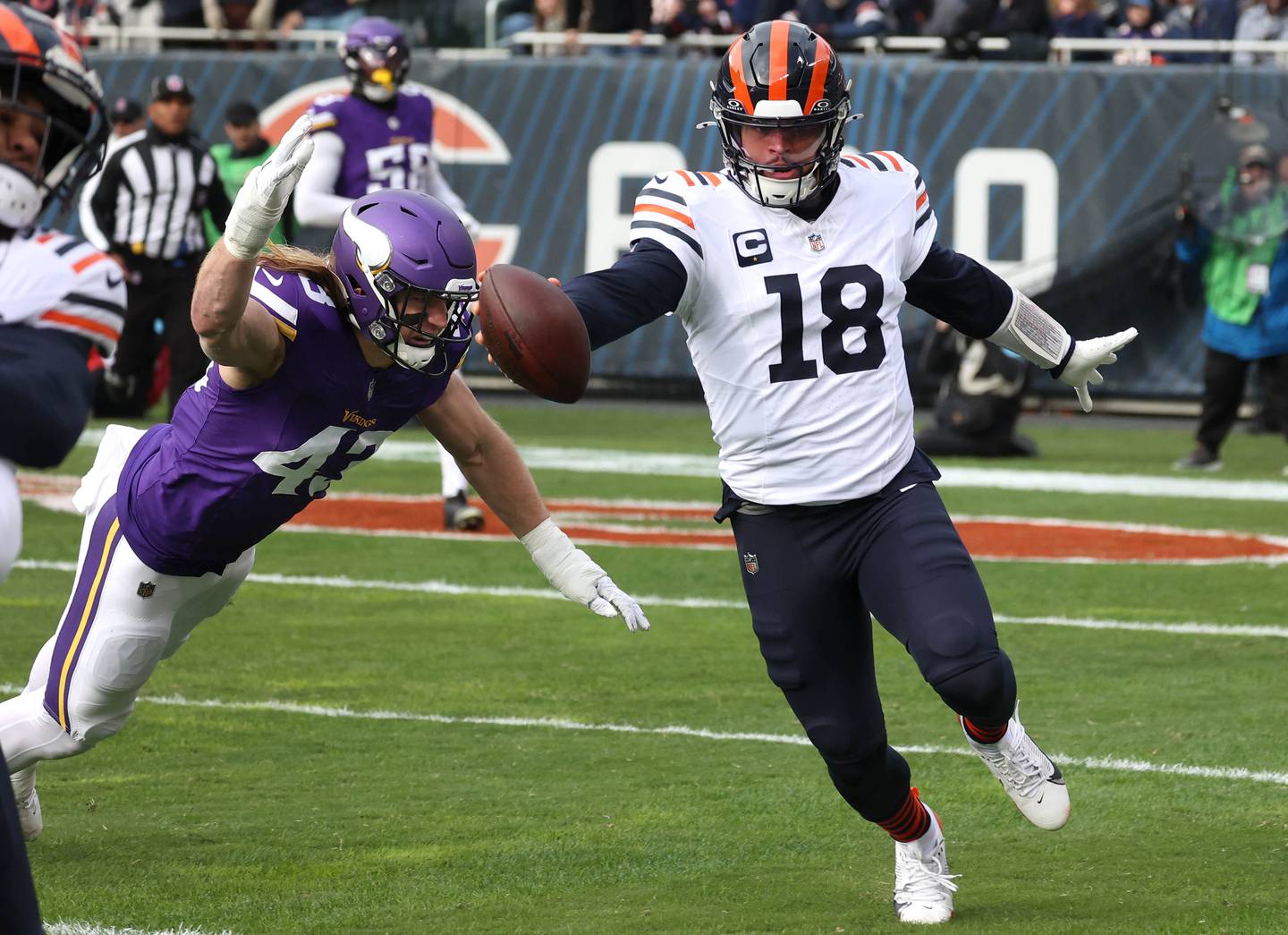 Chicago Bears quarterback Caleb Williams reaches to get a first down as Minnesota Vikings linebacker Andrew Van Ginkel tries to make the tackle during their game Sunday, Nov. 24, 2024, at Soldier Field in Chicago.