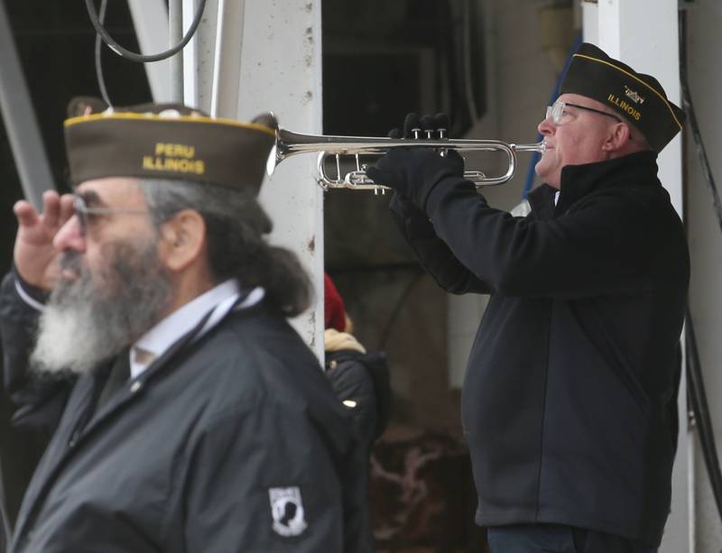 Gary Wood, of Ottawa (right) plays Taps during the 44th annual Pearl Harbor parade and memorial ceremony on Saturday, Dec. 2, 2023 in Peru.