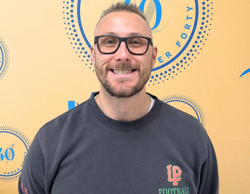 JJ Raffelson poses with his 40 Under Forty award during the Illinois Valley Chamber of Commerce Champions of Change Awards Night on Wednesday, May 6, 2026 at the Westclox Event Center in Peru.