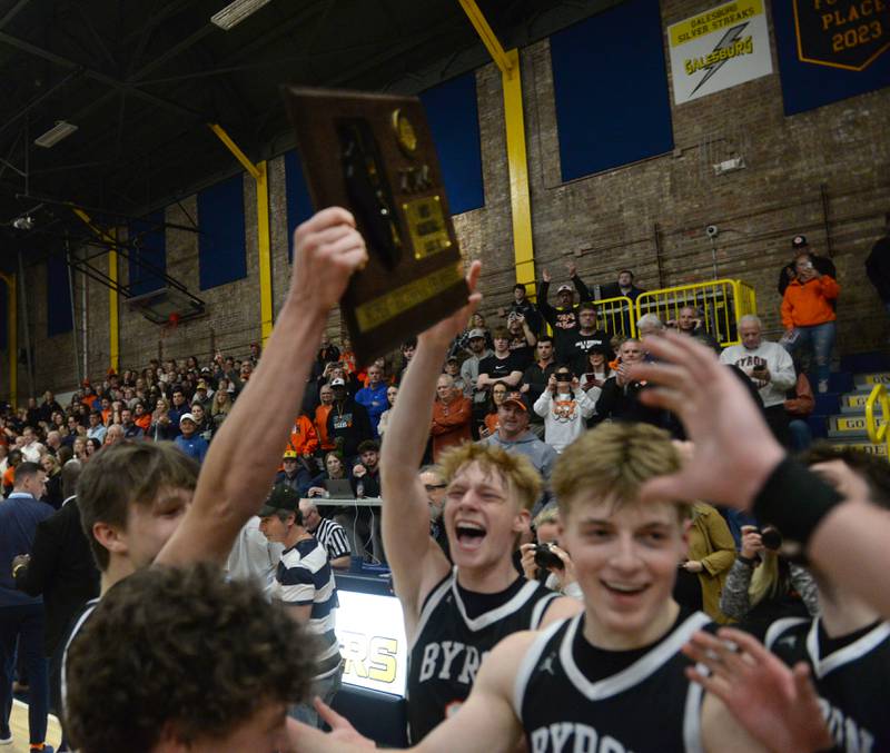 The Tigers celebrate as they hoist the trophy after winning the 2A Supersectional in Sterling on Monday, March 4, 2024. The Tigers beat Chicago Latin 85-71 to advance to the state finals this week in Champaign. Byron will play Benton at 3:45 p.m. on Thursday in the semifinals. The 2A championship is scheduled for Saturday at 1 p.m.
