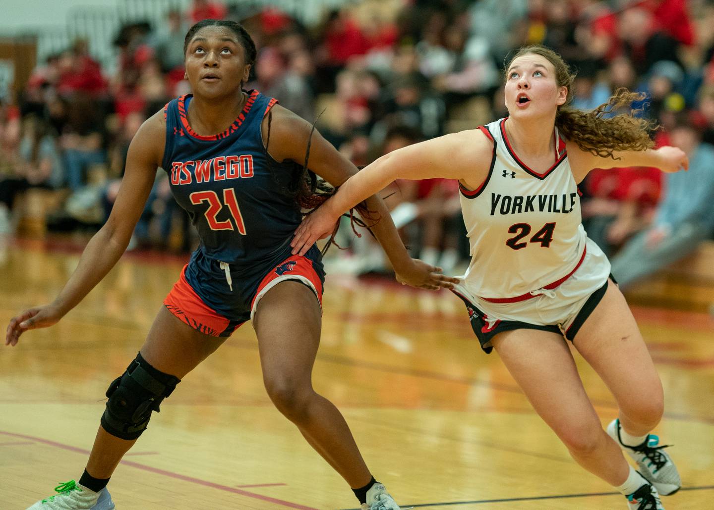 Oswego’s Kendall Fulton (21) and Yorkville's Ava Diqui (24) battle for position under the basket during the 13th annual Hoops 4 Hope Communities vs. Cancer basketball event at Yorkville High School on Saturday, Jan 28, 2023.