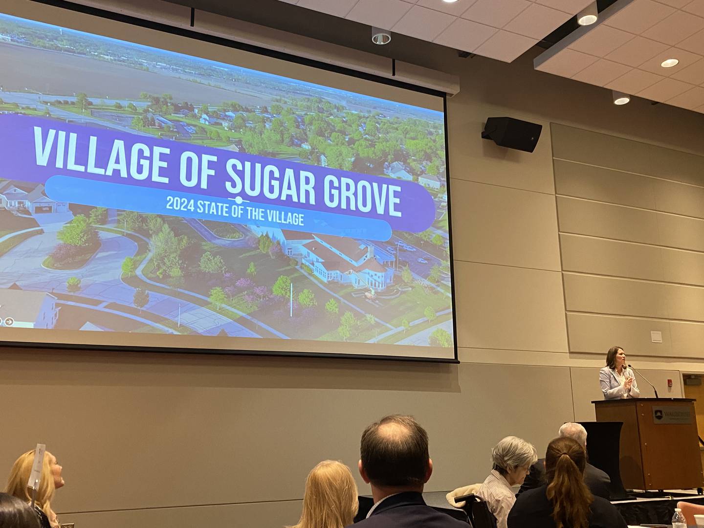 Audience members listen to Village of Sugar Grove President Jen Konen deliver her 2024 State of the Village at Waubonsee Community College on March 20.