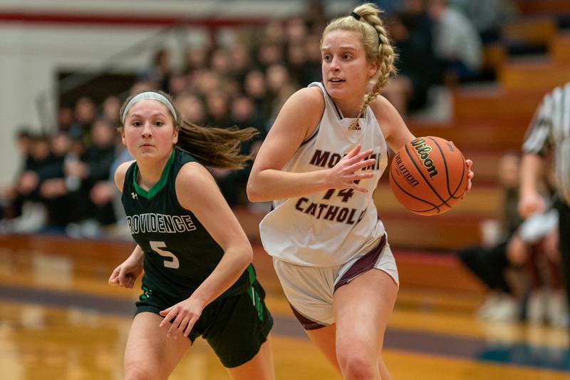 Montini’s Shannon Blacher (14) drives to the hoop against Providence's Sydney Spencer (5) during the 3A Glenbard South Sectional basketball final at Glenbard South High School in Glen Ellyn on Thursday, Feb 23, 2023.