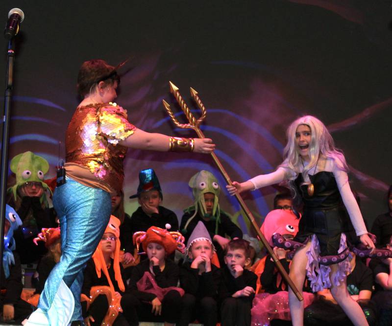 King Triton (Levi Petersen) reluctantly hands over Poseidon's trident to Ursula (Alexandria Pedelty) during the Streator Elementary Schools production of "The Little Mermaid Jr." Friday, May 5, 2023, at the Streator High School Auditorium.