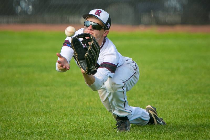 Prairie Ridge outfielder Will Komar (25) dives for a catch in the third inning of the game at Prairie Ridge on Wednesday, May 19, 2021, in Crystal Lake, Ill. The Wolves lost in extra innings, 12-10.