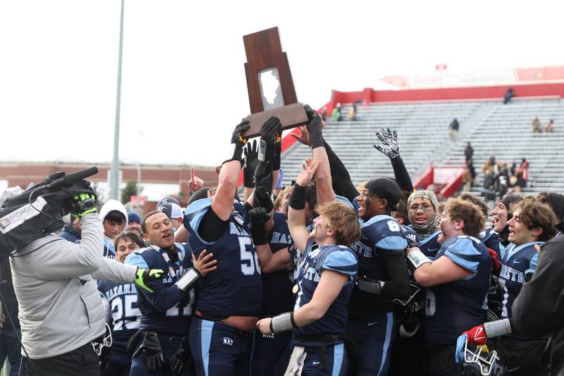 Nazareth holds up the championship trophy after defeating Joliet Catholic 29-27 in the Class 5A state championship on Saturday, Nov. 30, 2024 in Normal.