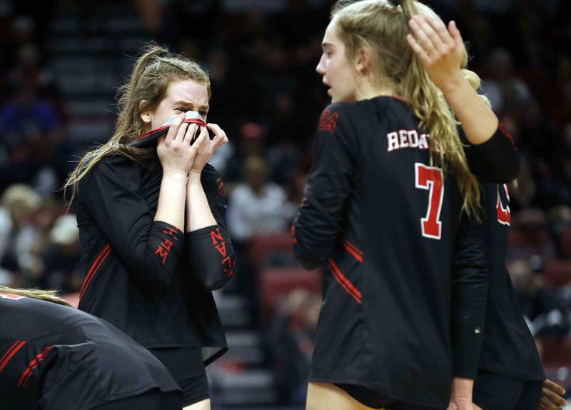 Benet’s Gabija Staniskis (18) is greeted by her teammates at the end of the IHSA Class 4A girls volleyball state title game between Benet Academy and Mother McAuley Saturday November 12, 2022 at Redbird Arena in Normal.