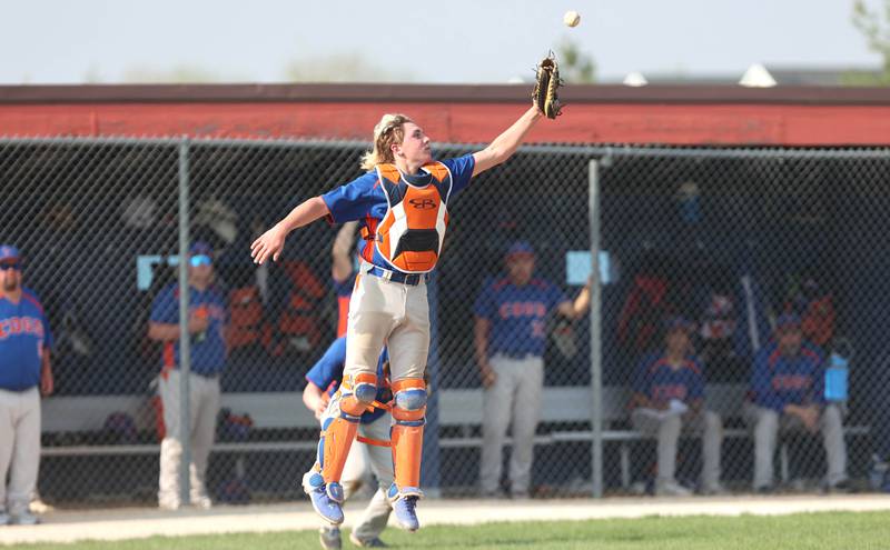 Genoa-Kingston's Tristan Swenson goes up high to try and catch an errant throw during a play at the plate during their game against Byron Tuesday, May 10, 2022, at Genoa-Kingston High School.