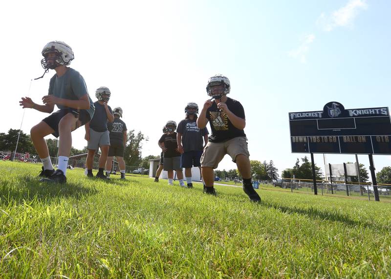 Members of the Fieldcrest football team work on drills before camp on Tuesday July 13, 2021.