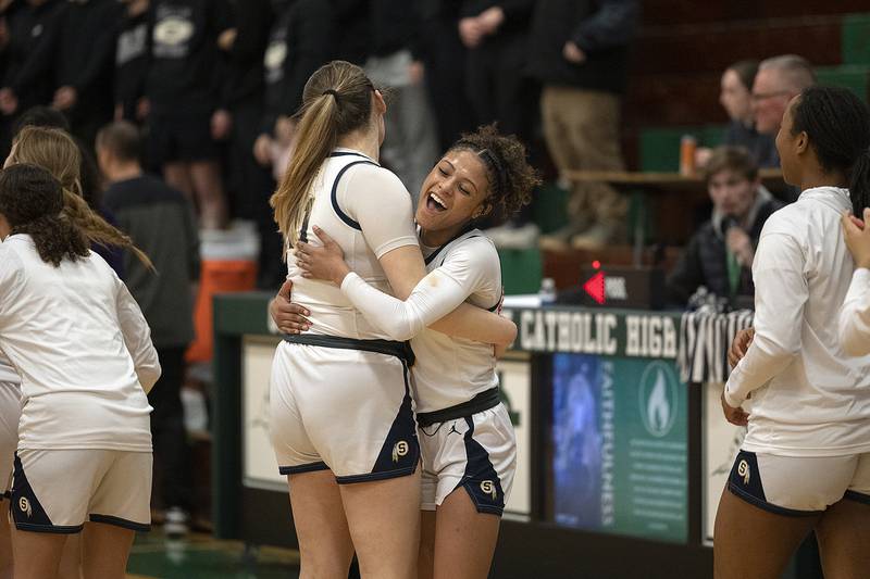 Sterling’s Madison Austin (left) and Delali Amankwa celebrate their 39-30 win over Dixon Thursday, Feb. 27, 2025, during the Class 3A girls Sectional title at Rockford Boylan High School.
