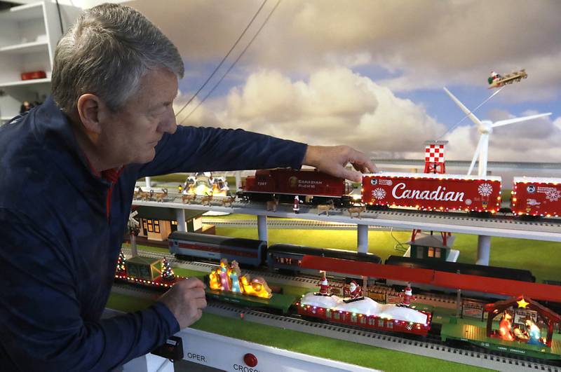 John Smith, president of the McHenry Riverwalk Foundation, with his holiday-themed trains on Thursday, Dec. 19, 2024, at his home in McHenry. He has been opening up his garage along the riverwalk during the weekends for people to see the trains.