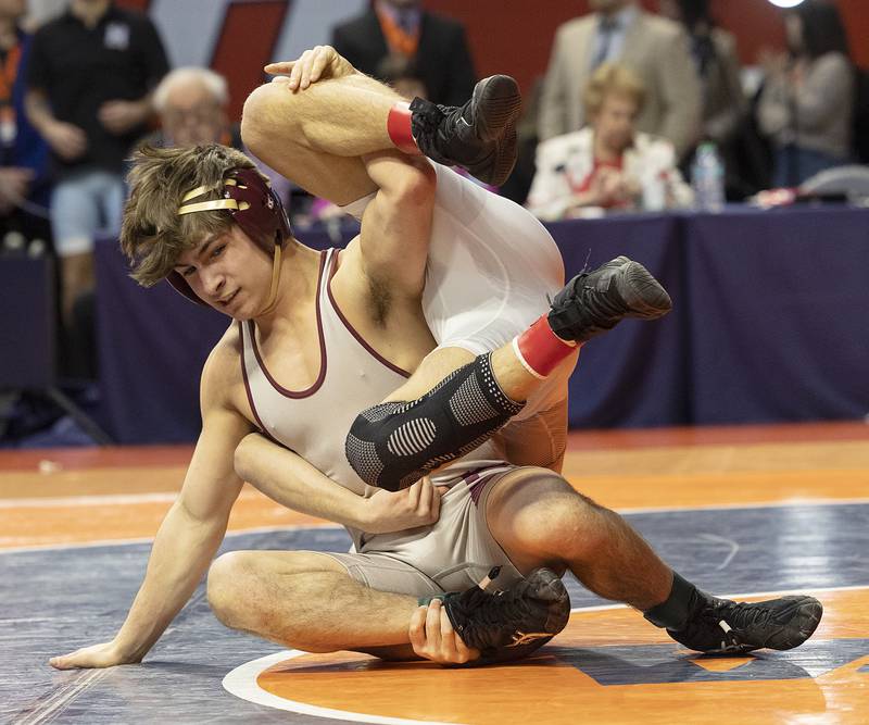 Richmond-Burton’s Emmett Nelson flips Unity Christian’s  Kaden Inman in the 144 pound weight class of the 1A state individual wrestling finals Saturday, Feb. 22, 2025, at State Farm Center in Champaign.
