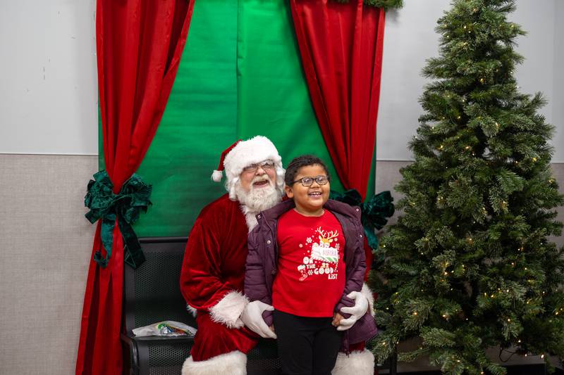A young shopper smiles with Santa after enjoying a holiday cookie and picking out all the best gifts during the annual Shop with a Cop event on Saturday, December 14, 2024 at the Dixon Walmart.