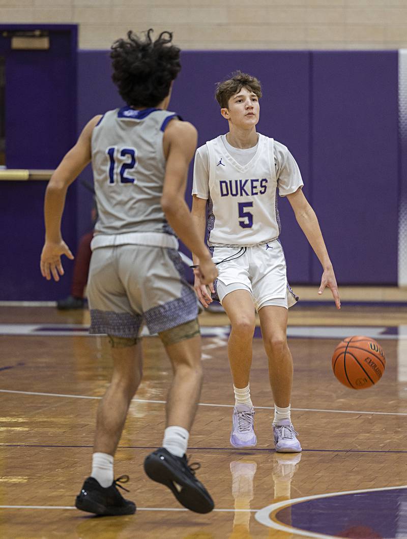 Dixon’s Brody Nicklaus handles the ball against Plano Wednesday, Dec. 6, 2023 at Dixon High School.