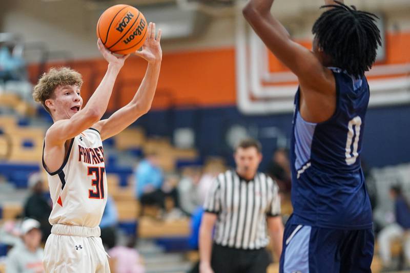 Oswego’s Brayden Borrowman (30) shoots a three pointer against Plainfield South's Kareem Parker (0) during a basketball game at Oswego High School on Friday, January 17, 2025.