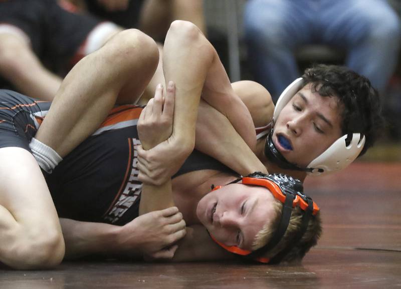 Huntley’s Cameron Abordories controls McHenry’s Cameron Abordo during the 113-pound match of a Fox Valley Conference boys wrestling match Thursday, Jan. 11, 2024, at McHenry High School.