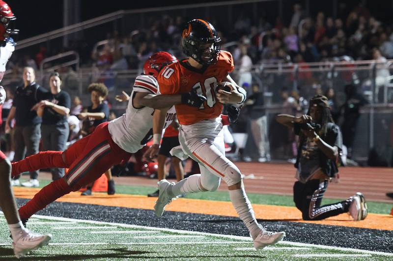 Lincoln-Way West’s Chase Hetfieisch scrambles for a touchdown against Bolingbrook on Friday, Sept. 22 in New Lenox.