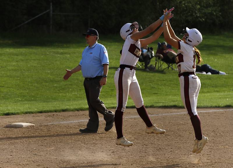 Richmond-Burton's Hailey Holtz high fives her teammate, Gabby Hird, after Richmond-Burton' defeated Marengo in a Kishwaukee River Conference softball game on Monday, May 12, 2025, at Richmond-Burton High School in Richmond.