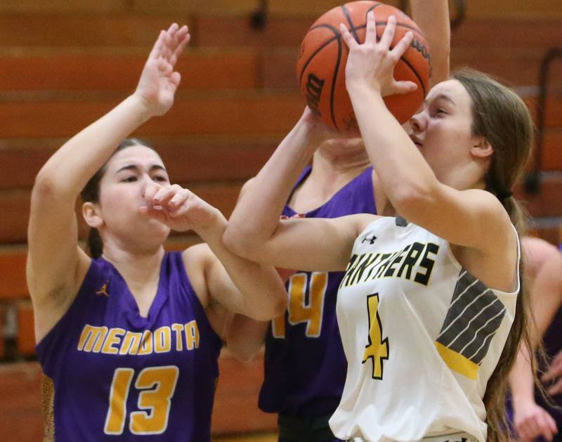 Putnam County's Sarah Johnson cuts in the lane to score over Mendota's Ella Martin during the Princeton High School Lady Tigers Holiday Tournament on Tuesday, Nov. 14, 2023 in Prouty Gym.