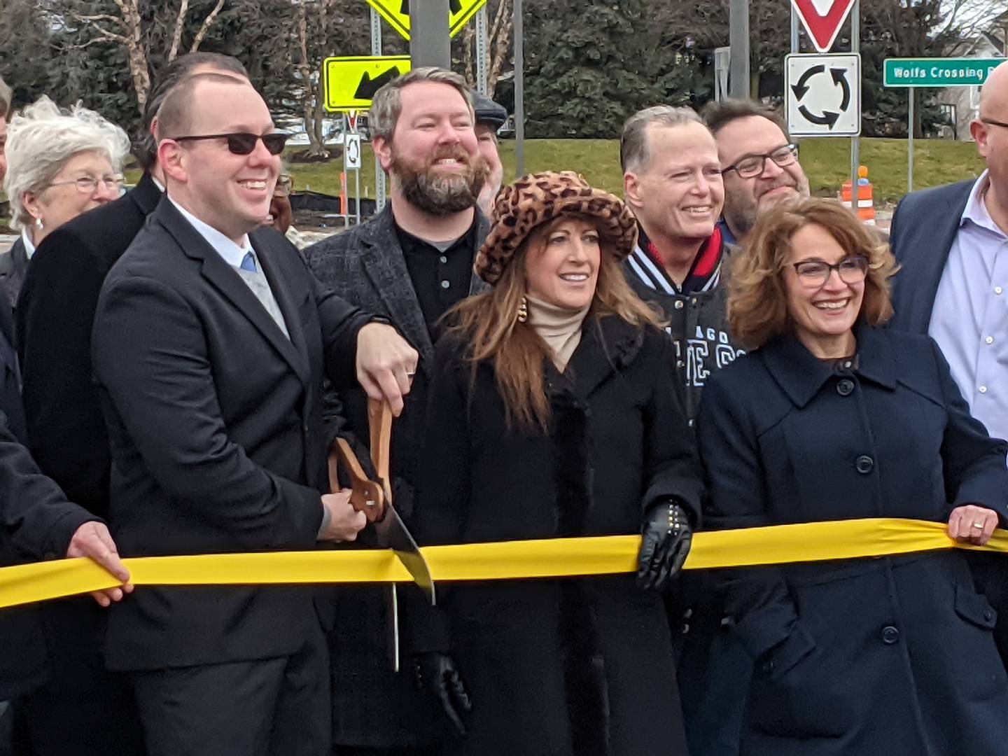 Surrounded by local and state officials, Oswego Village President Ryan Kauffman cut the ribbon Dec. 29 on the village's first roundabout, part of a project to improve Wolfs Crossing.