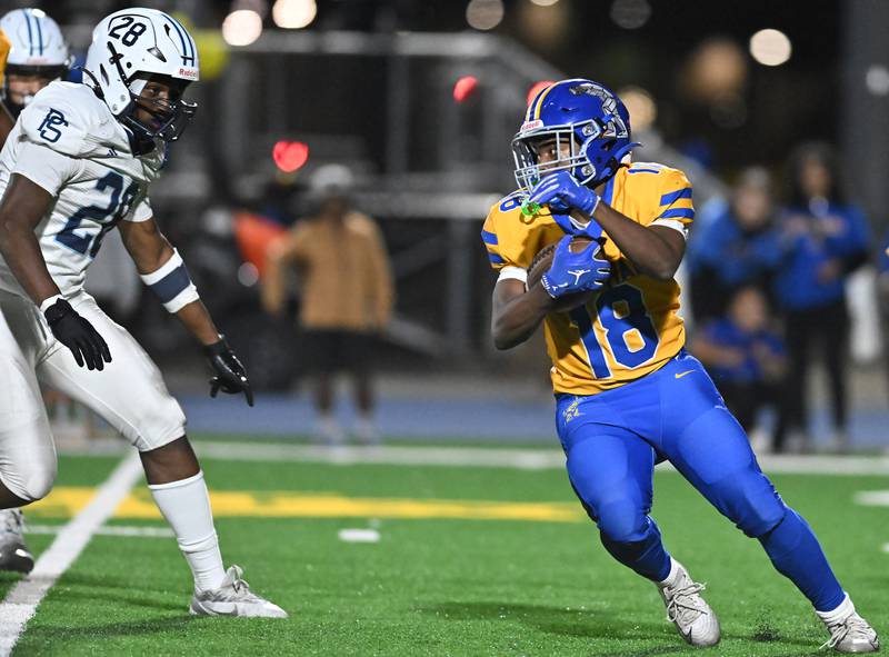 Joliet Central's Tristen Sellers (18) looks for a opening during the conference game against Plainfield South on Friday, OCT. 17, 2025, at Joliet.