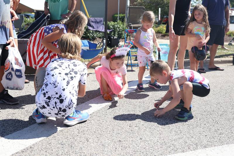 Birthday girl Finley Dobrovits, 8-years old, center, collects candy with her friends at the Manhattan Labor Day Parade on Monday, Sept. 4, 2023 in Manhattan.