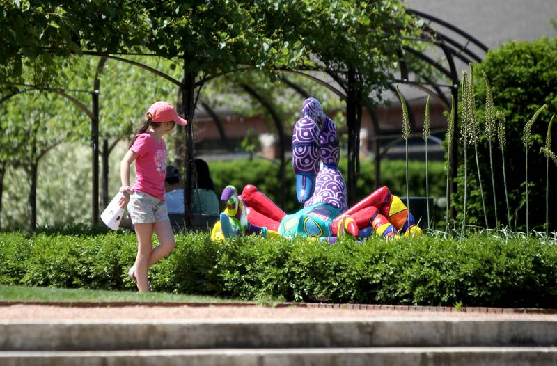 Madison Steinbuck, 8, checks out some of the sculptures that are part of “Alebrijes: Creatures of a Dream World” at Cantigny Park in Wheaton. The park-wide outdoor art exhibit featuring dozens of imaginary creatures inspired by Mexican folklore is on display through October.
