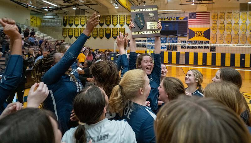 Oswego East's Samantha Trujillo (6) raises the 4A regional championship plaque in celebration after defeating Neuqua Valley at Neuqua Valley High School in Naperville on Thursday, Oct 27, 2022.