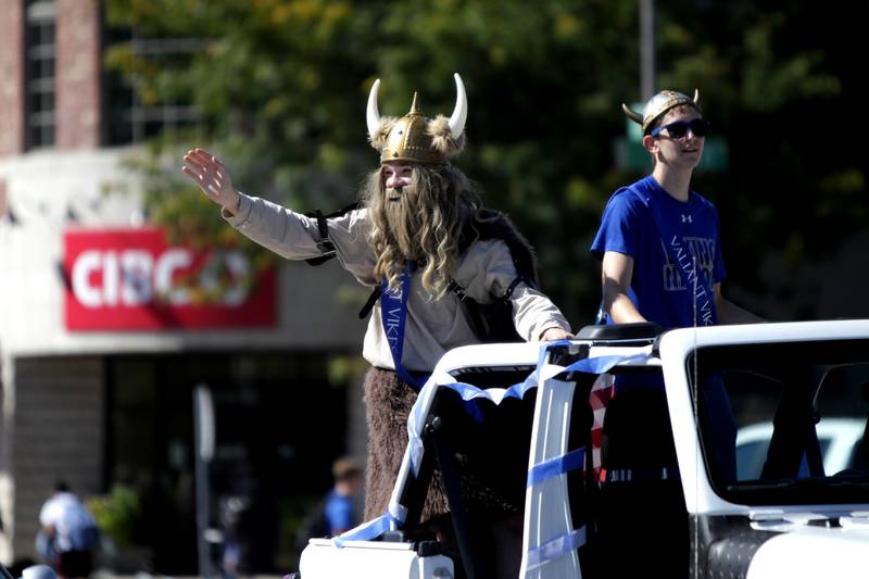 Geneva High School students Jackson Greibel (left) and Andrew Wendt ride in the back of a jeep during the school’s annual homecoming parade on State Street on Friday, Sept. 15, 2023.