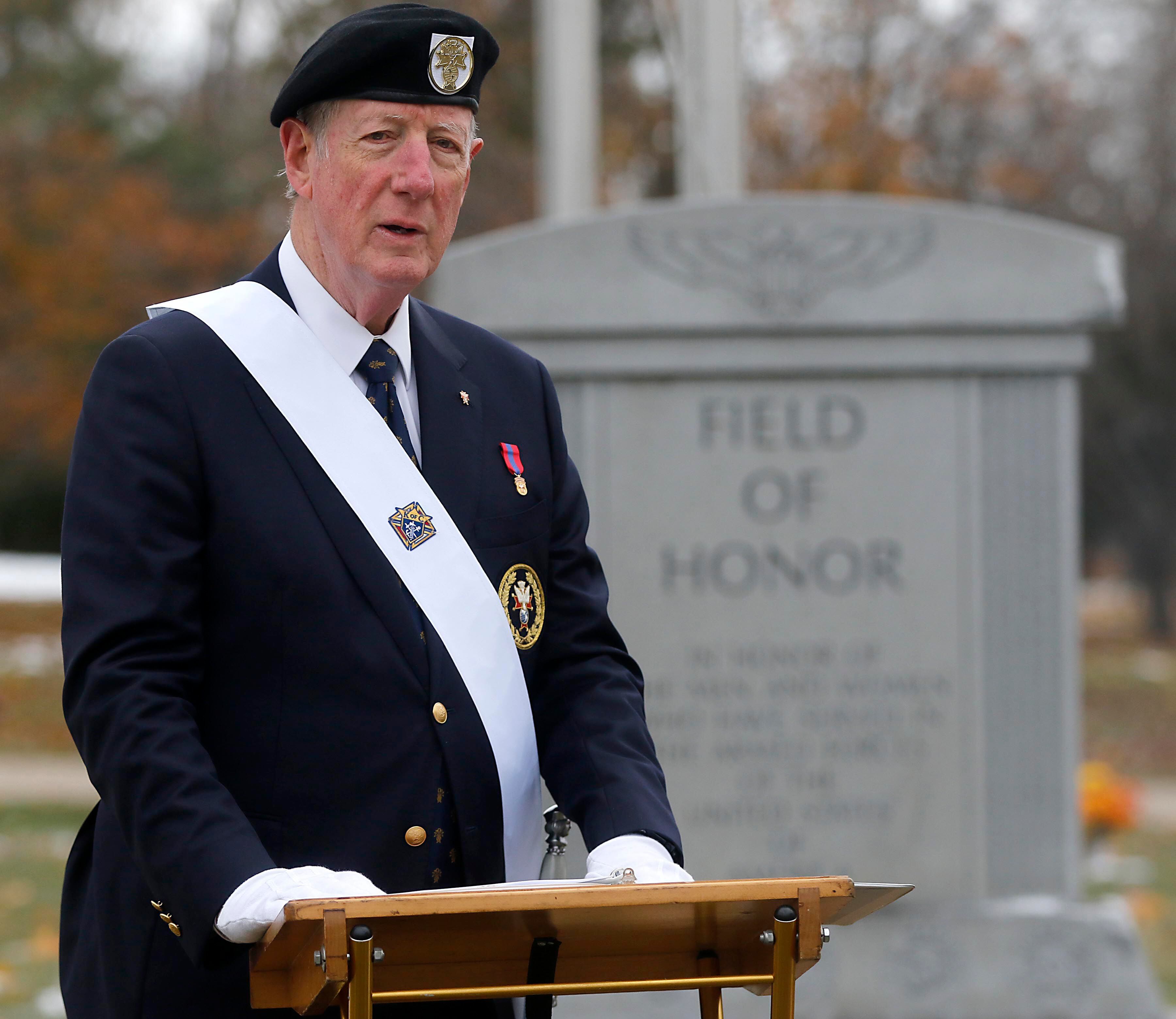 Bob Schafer speaks during the Veterans Day flag placement ceremony Tuesday, Nov. 11, 2025, at the gravesites of veterans at McHenry County Memorial Park Cemetery in Woodstock. Members of the Knights of Columbus Patriotic 4th Degree from the Bishop Boylan Assembly placed American Flags at nearly 140 veterans' grave markers.