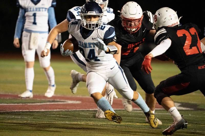 Nazareth Academy's Alexander Angulo (24) carries the ball against Benet Academy during a football game at Benedictine University in Lisle on Friday, Oct 21, 2022.