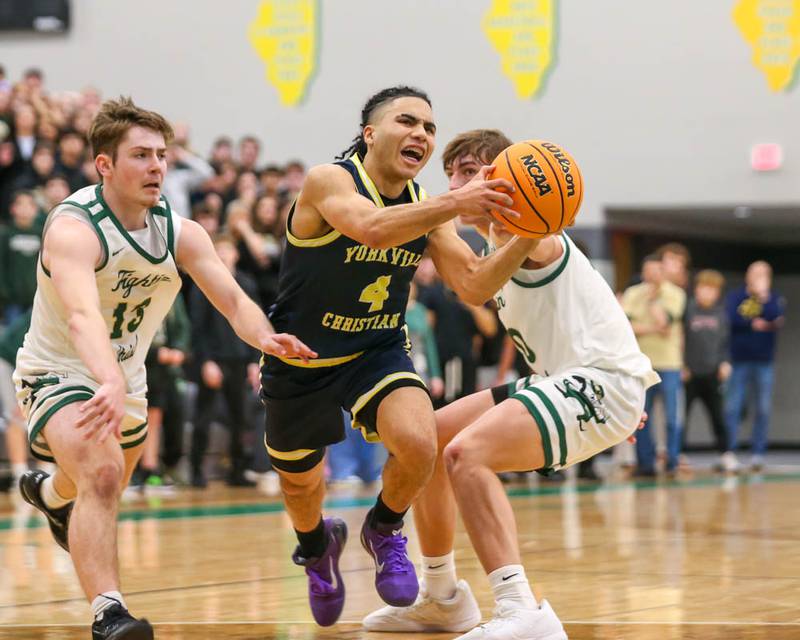Yorkville Christian's Tray Alford (4) drives to the basket during their Class 2A Seneca Sectional final basketball game between Bishop McNamara at Yorkville Christian, March 6, 2026 in Senaca.