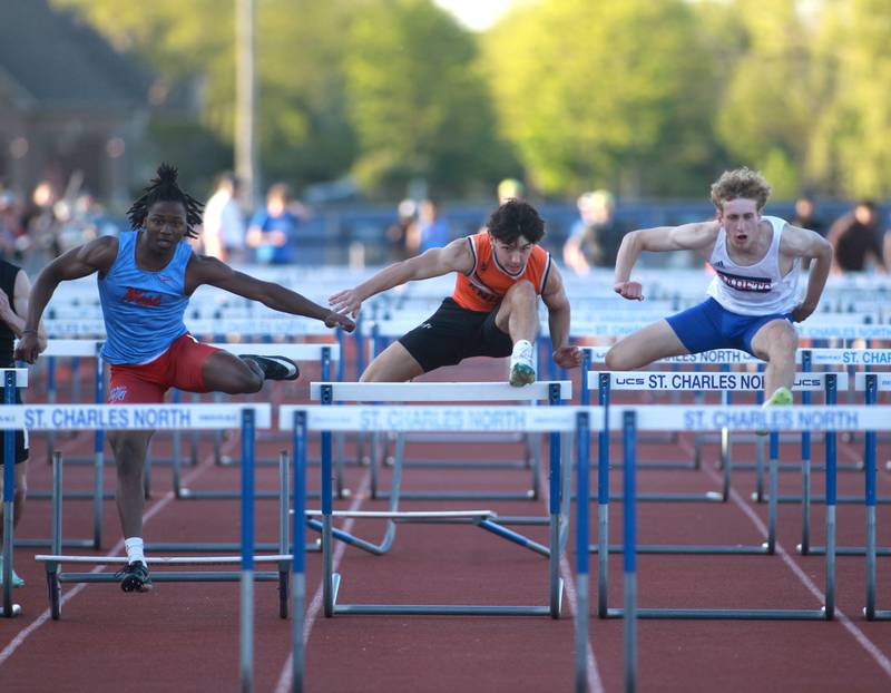 (Left to right) West Aurora’s Azuriah Sylvester, Kaneland’s Luke Gadomski and Marmion’s Patrick Fitzgerald compete in the 110-meter hurdles during the Kane County boys track and field championships on Friday, May 9, 2025 at St. Charles North.