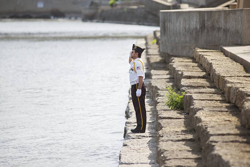 Dave Devine salutes during the playing of taps Monday, May 30, 2022 at the Dixon riverfront to honor the sailors who died at sea.