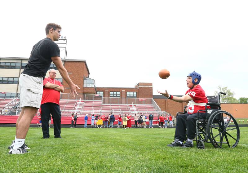 Ottawa HIgh School quarterback Joe Ovanic throws a toss to Greg Atz to score a touchdown on King Field on Tuesday, May 17, 2022 at Ottawa High School. Atz always wanted to play quarterback for the Ottawa Pirates and with the help of the Ottawa Friendship House and the high school his lifelong dream was fulfilled.