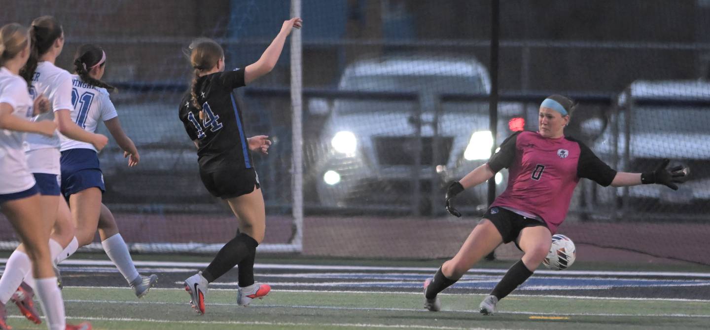 St. Charles North’s Laine Griswold gets a shot past Geneva goalkeeper Katelyn Johnson for a score in a girls soccer game in St. Charles on Thursday, Apr. 9, 2026.