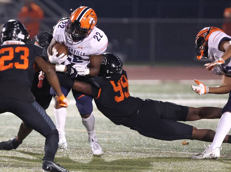DeKalb’s Pierre Cathina makes a diving tackle off Naperville North's Lonzo Duckworth during their game Friday, Sept. 22, 2023, at DeKalb High School.