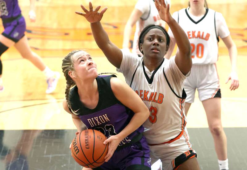 Dixon’s Hannah Steinmeyer looks to score in the paint over DeKalb's Cayla Evans during their game Monday, Jan. 23, 2023, at DeKalb High School.