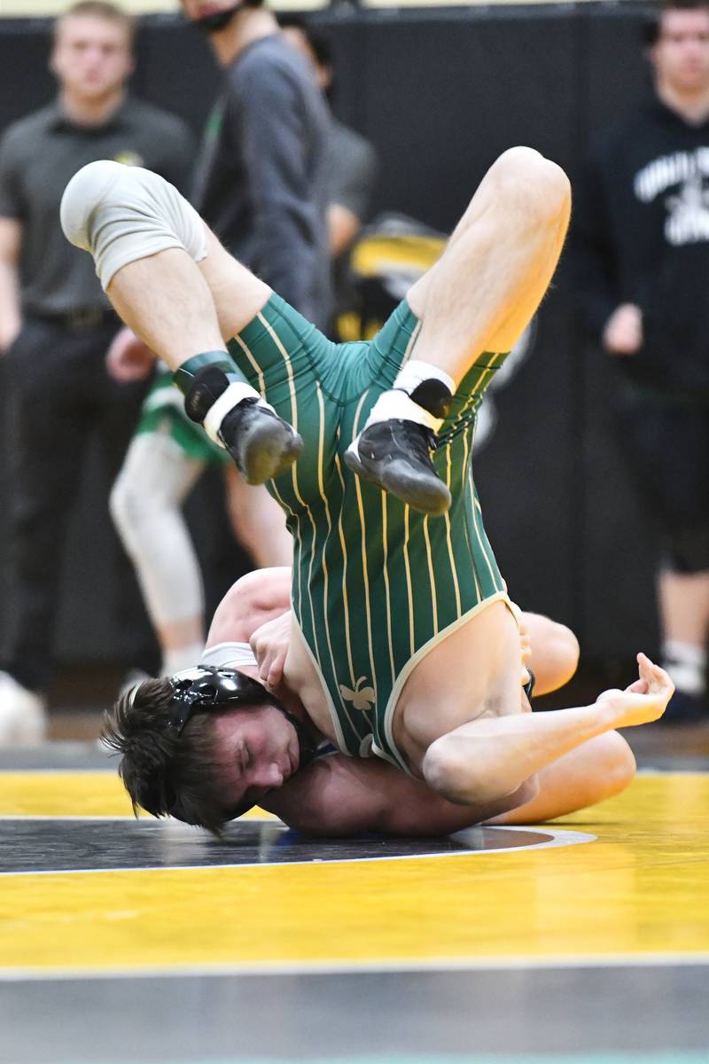 Peotone's Dalton Sala wrestles Bishop McNamara's Cole Kimberlin during Sala's 144-pound match victory on Saturday, Feb. 8, 2025, in the IHSA Class 1A Herscher regional.