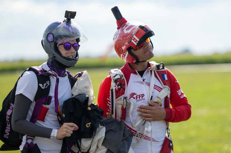 (from left) Courtney Moore and Greg Crozier soak in experience after successfully landing in drop zone on Friday, Aug 22, 2025 above Skydive Chicago in Ottawa.